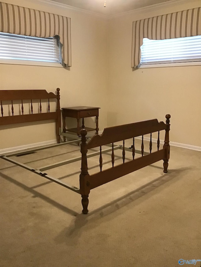 carpeted bedroom featuring multiple windows and crown molding