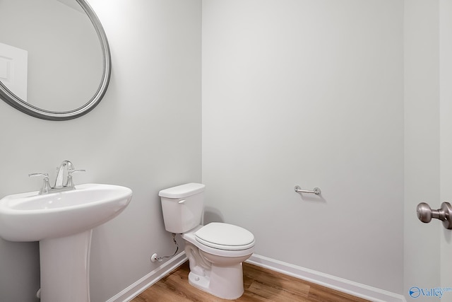 182 Saddle St, New Market, AL 35761 - bathroom featuring sink, hardwood / wood-style floors, and toilet