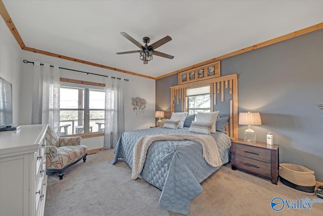 bedroom with light carpet, ceiling fan, baseboards, and crown molding