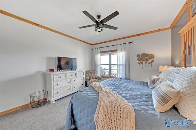 carpeted bedroom featuring baseboards, ceiling fan, and crown molding