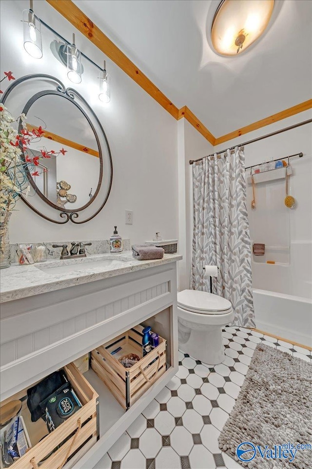 bathroom with crown molding, toilet, shower / tub combo, vanity, and tile patterned floors