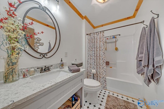 bathroom with ornamental molding, shower / bath combo with shower curtain, vanity, and toilet