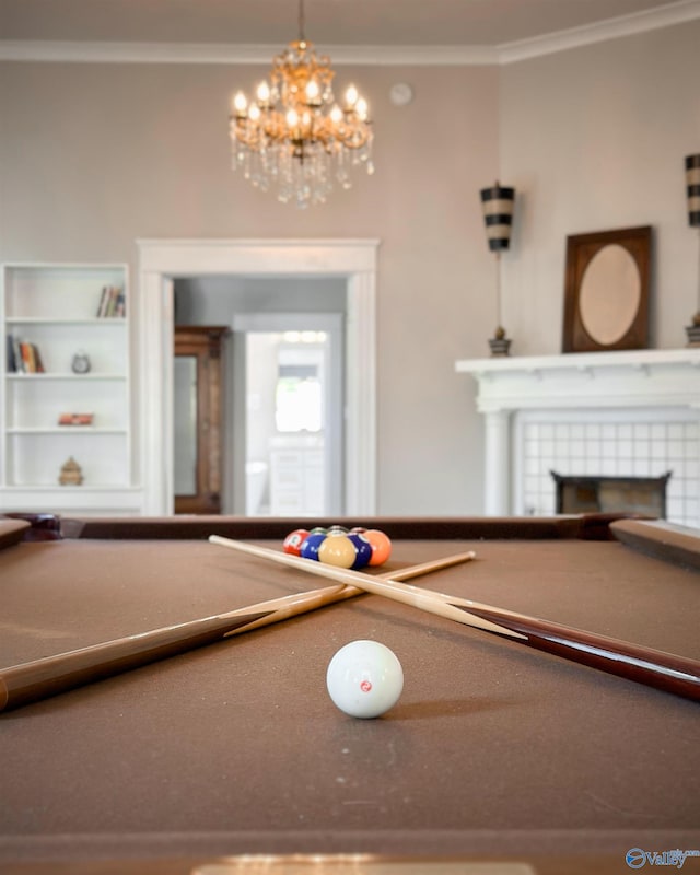 605 Ferry St, Decatur, AL 35601 - rec room with crown molding, a chandelier, and a fireplace