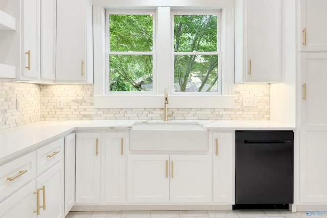 605 Ferry St, Decatur, AL 35601 - kitchen featuring black dishwasher, a sink, white cabinetry, and healthy amount of natural light