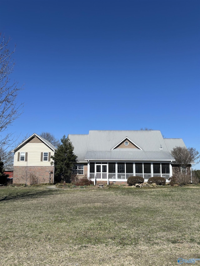view of front facade with brick siding and a front yard