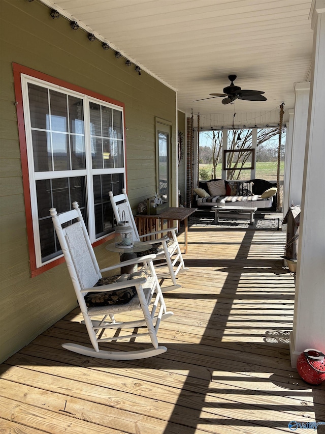 deck with a porch and ceiling fan