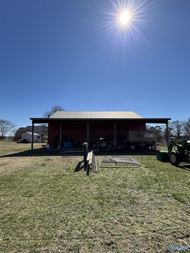 view of pole building with a carport and a yard