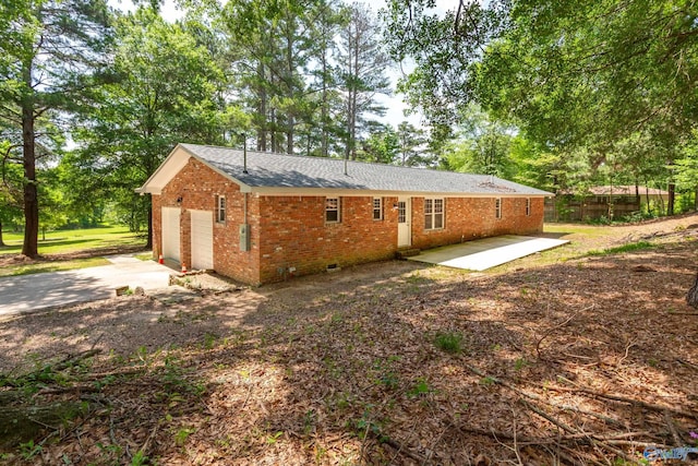 2810 Mountain View Dr, Southside, AL 35907 - rear view of property featuring brick siding, crawl space, a patio, a garage, and view of wooded area