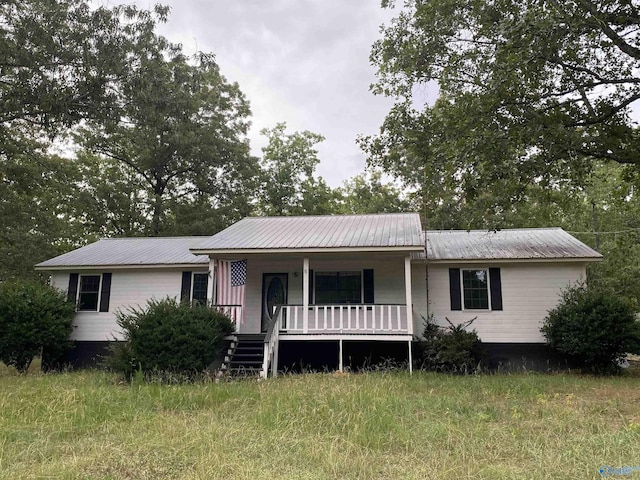 ranch-style house featuring metal roof and a porch