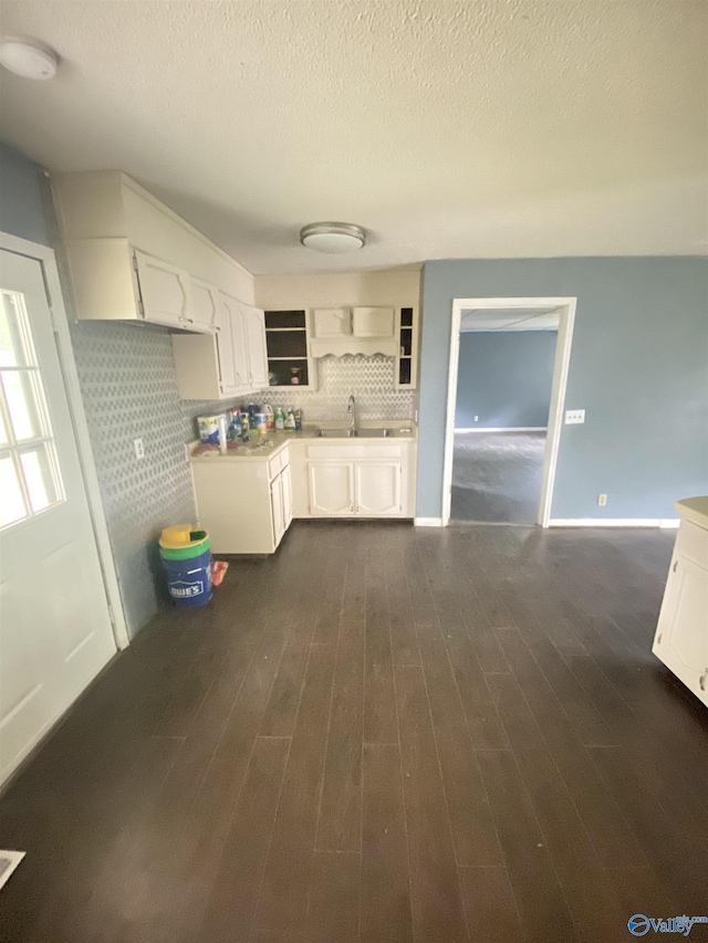 kitchen with dark wood-style flooring, white cabinets, decorative backsplash, and open shelves