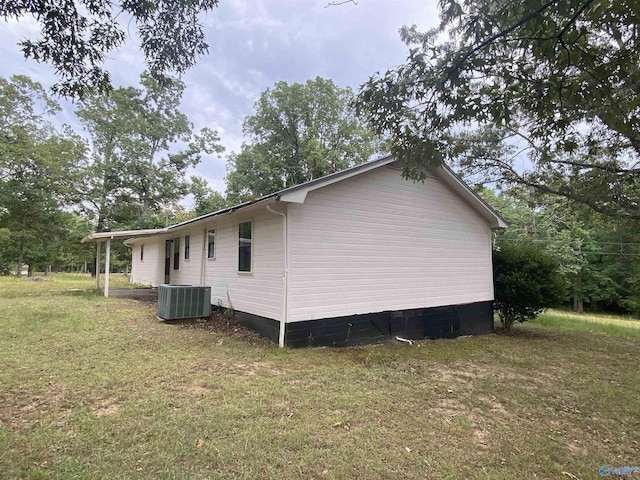 view of property exterior with a lawn and cooling unit