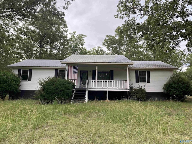 view of front of house with covered porch and metal roof