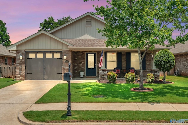 2626 SW Ashtynn Pl, Huntsville, AL 35803 - view of front of home with covered porch, an attached garage, driveway, a front lawn, and a shingled roof