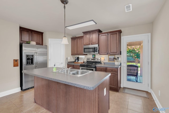 2626 SW Ashtynn Pl, Huntsville, AL 35803 - kitchen featuring appliances with stainless steel finishes, light tile patterned floors, pendant lighting, and a center island with sink