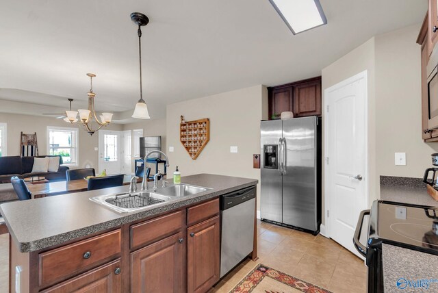 2626 SW Ashtynn Pl, Huntsville, AL 35803 - kitchen featuring stainless steel appliances, a chandelier, open floor plan, a kitchen island with sink, and light tile patterned floors