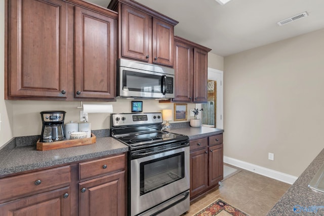 2626 SW Ashtynn Pl, Huntsville, AL 35803 - kitchen with stainless steel appliances and dark countertops