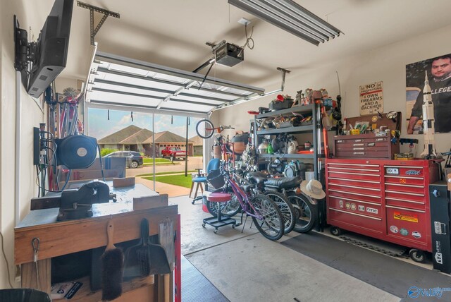 2626 SW Ashtynn Pl, Huntsville, AL 35803 - garage featuring a garage door opener and a workshop area
