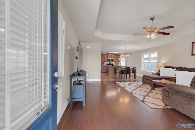2626 SW Ashtynn Pl, Huntsville, AL 35803 - living room with ceiling fan, dark wood-style floors, a chandelier, and a raised ceiling