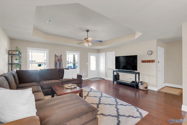 2626 SW Ashtynn Pl, Huntsville, AL 35803 - living room featuring a raised ceiling, dark wood-style floors, and ceiling fan