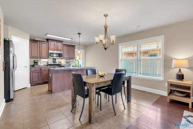 2626 SW Ashtynn Pl, Huntsville, AL 35803 - dining space with healthy amount of natural light, a chandelier, and light tile patterned flooring