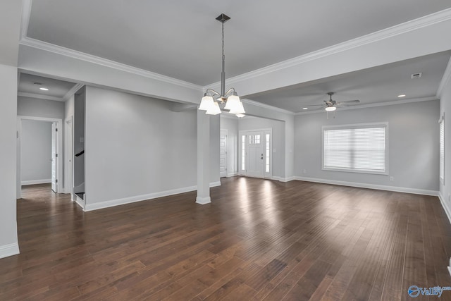 spare room with dark wood-type flooring, ceiling fan with notable chandelier, and crown molding