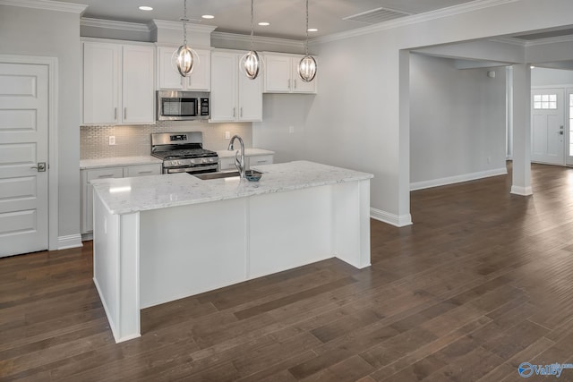 kitchen with pendant lighting, dark hardwood / wood-style flooring, a center island with sink, stainless steel appliances, and white cabinets