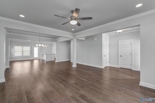 unfurnished living room featuring sink, ceiling fan with notable chandelier, crown molding, and dark hardwood / wood-style flooring