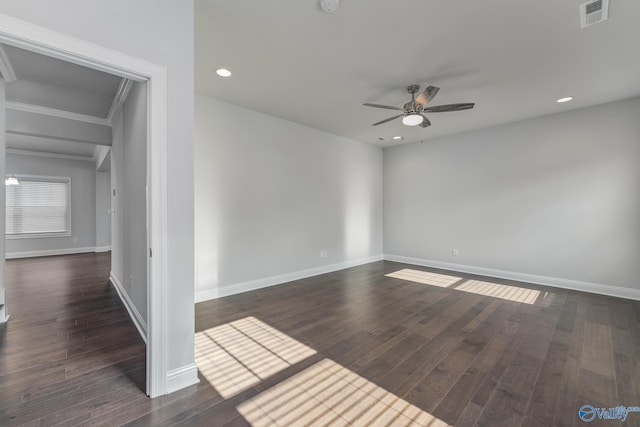 spare room with crown molding, dark hardwood / wood-style flooring, and ceiling fan