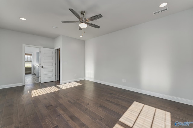 empty room featuring ceiling fan and dark wood-type flooring