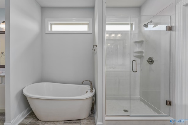 bathroom with separate shower and tub and a wealth of natural light