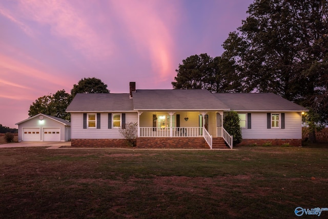 ranch-style house with an outdoor structure, a lawn, covered porch, and a garage