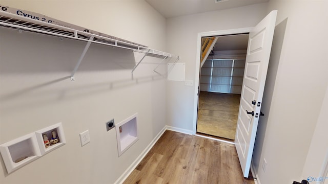 washroom with hookup for a washing machine, hookup for an electric dryer, and light wood-type flooring