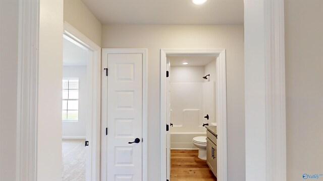 corridor with light hardwood / wood-style flooring