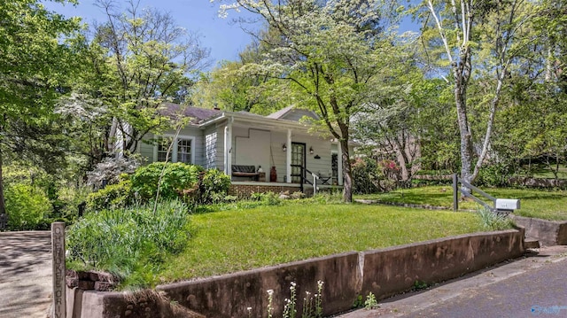exterior space featuring a porch and a front lawn
