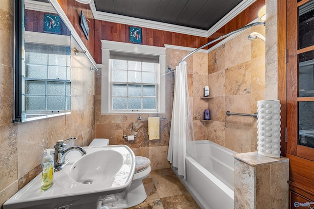 bathroom with toilet, ornamental molding, a sink, tile walls, and shower / bath combo with shower curtain