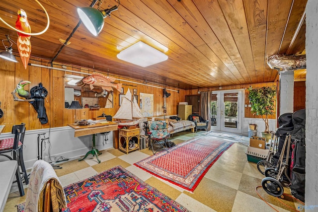 interior space featuring wooden walls, tile patterned floors, wooden ceiling, and french doors