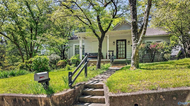 view of front of house with a porch and a front lawn