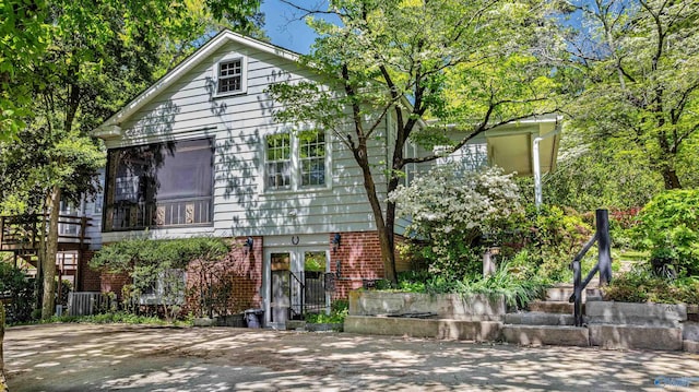 view of front of property featuring french doors and brick siding