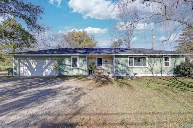 single story home with a garage and a front lawn