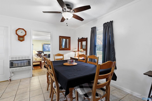 dining area with ceiling fan, light tile patterned flooring, ornamental molding, and heating unit