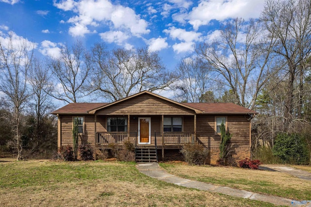 view of front of property with covered porch and a front lawn