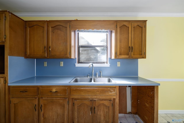 kitchen featuring ornamental molding, sink, and light tile patterned floors