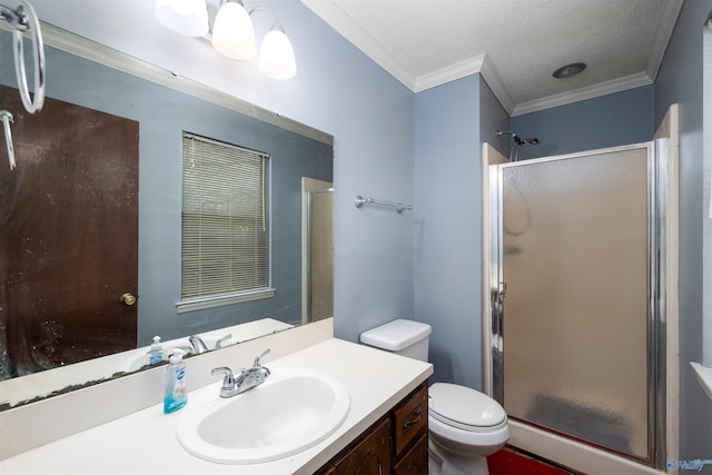 bathroom with toilet, a shower with door, a textured ceiling, crown molding, and vanity