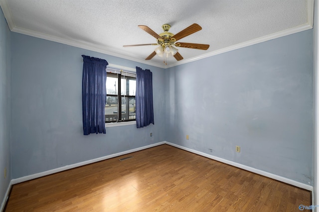 spare room featuring ceiling fan, hardwood / wood-style flooring, crown molding, and a textured ceiling