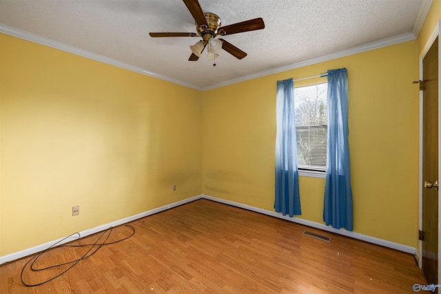 unfurnished room featuring a textured ceiling, ornamental molding, ceiling fan, and light hardwood / wood-style floors