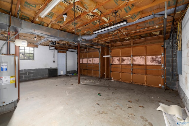 garage featuring electric panel and electric water heater