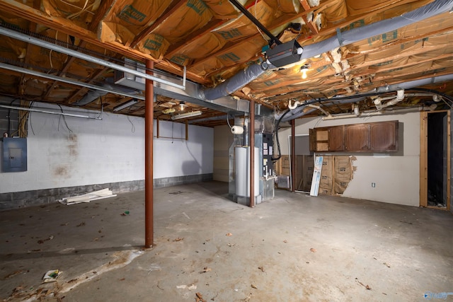 basement with electric panel and gas water heater