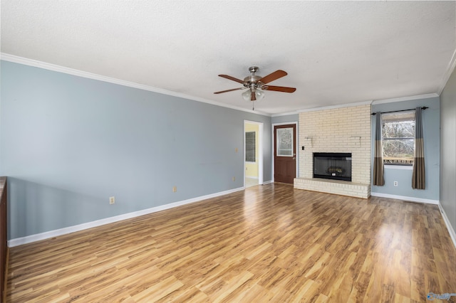 unfurnished living room featuring a fireplace, light hardwood / wood-style flooring, ceiling fan, a textured ceiling, and crown molding