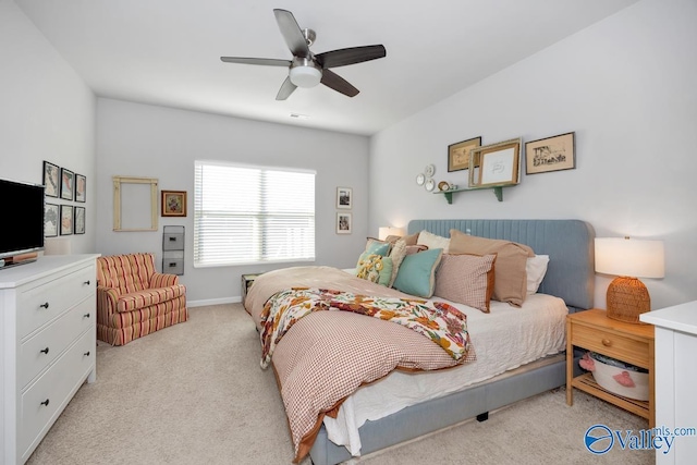 bedroom with a ceiling fan and light colored carpet