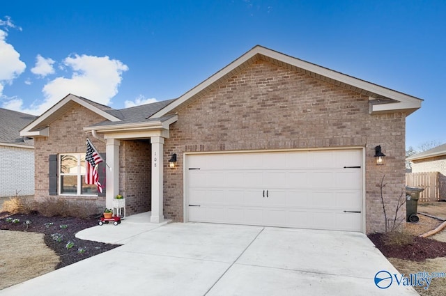 ranch-style house with an attached garage, a shingled roof, concrete driveway, and brick siding